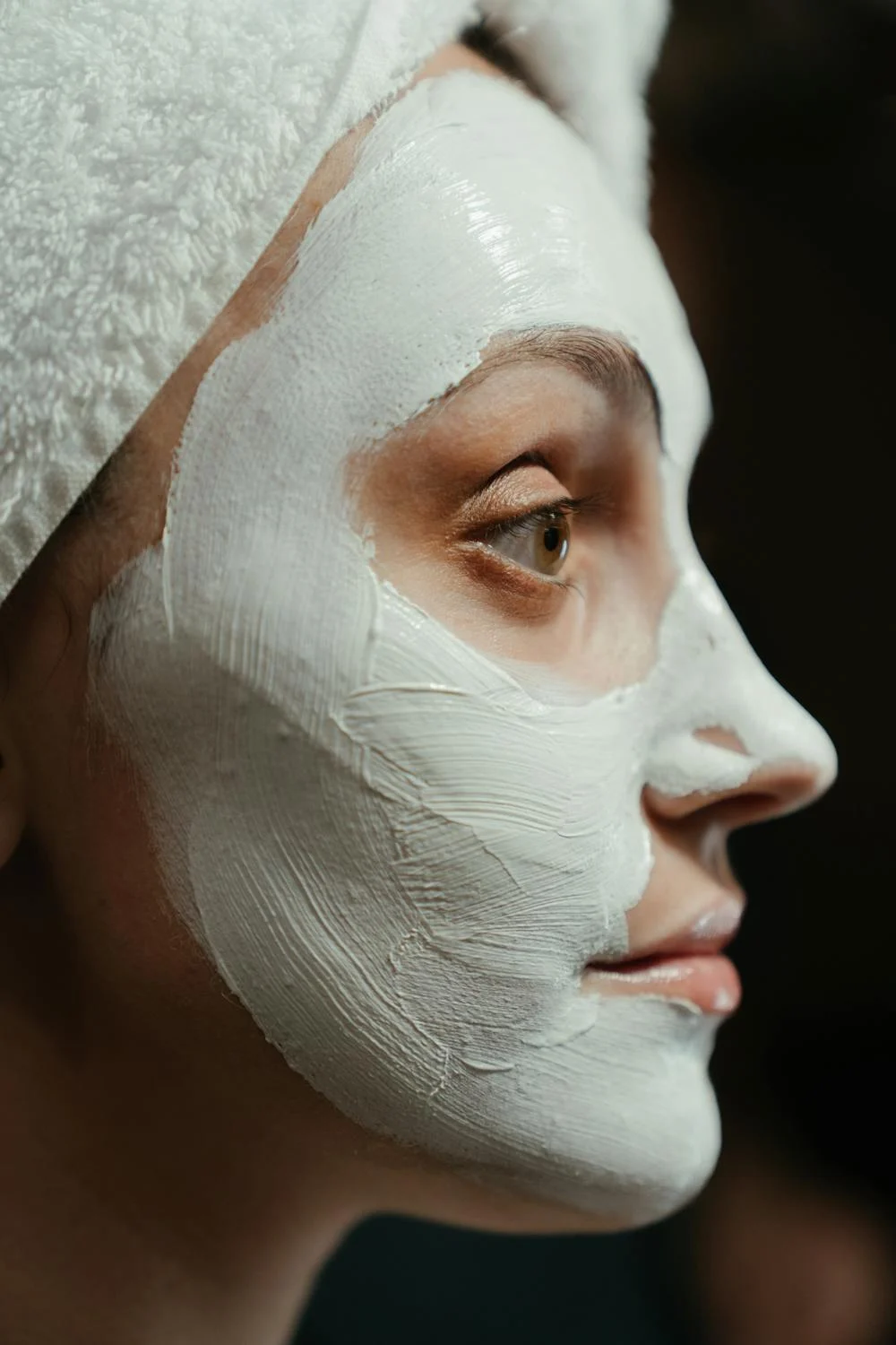 sideview of a woman's face with a face scrub on