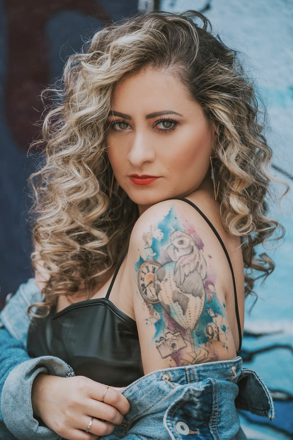 photo of a woman with tattoos looking in front of the camera
