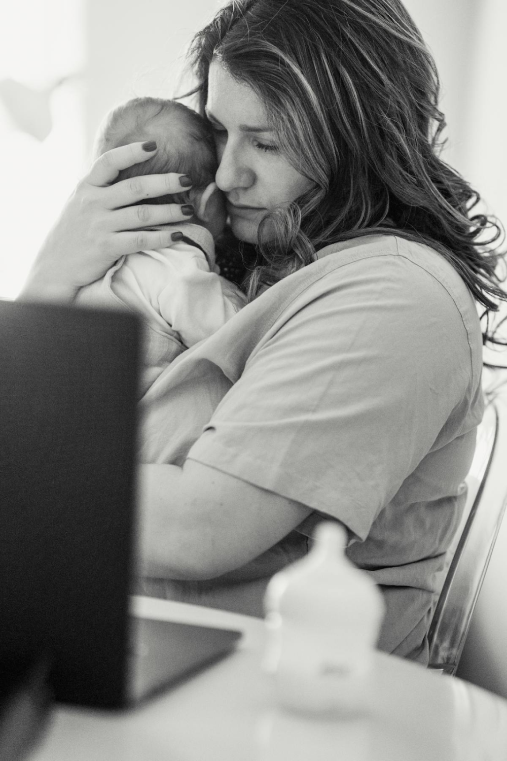 black and white photo of a woman holding her baby