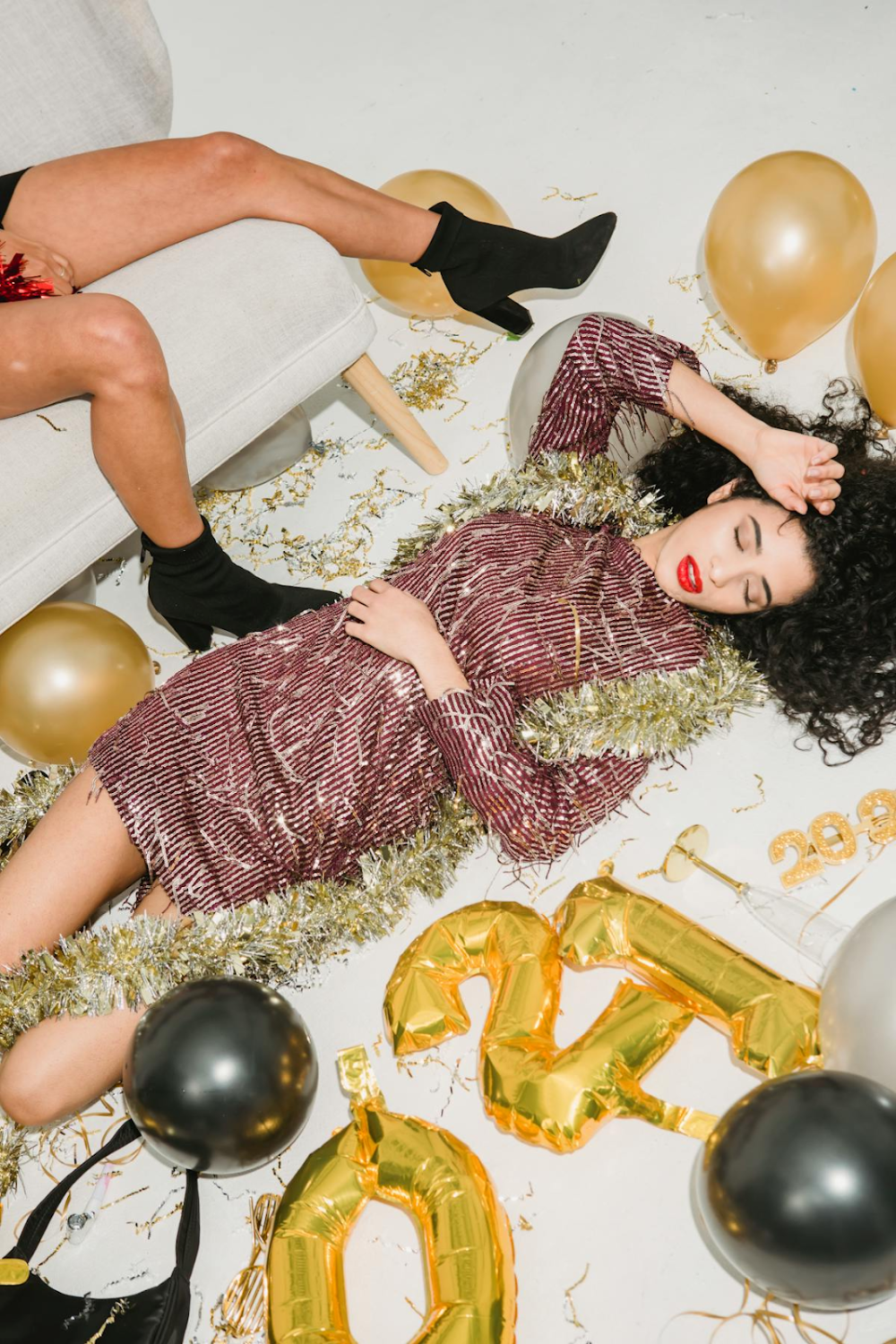 a woman lying down wearing a party dress
