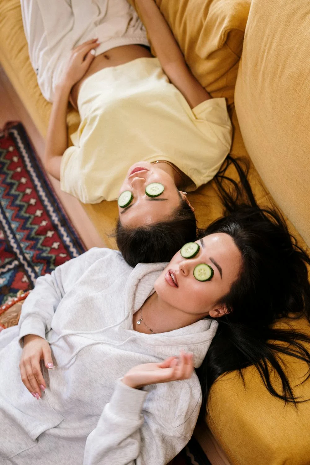 Woman in White Shirt Relaxing with Cucumber Slices Placed in Between Her Eyes